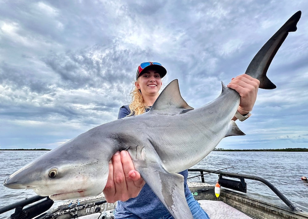 Woman holding Bull Shark on a Fishing Charter in Crystal River Florida