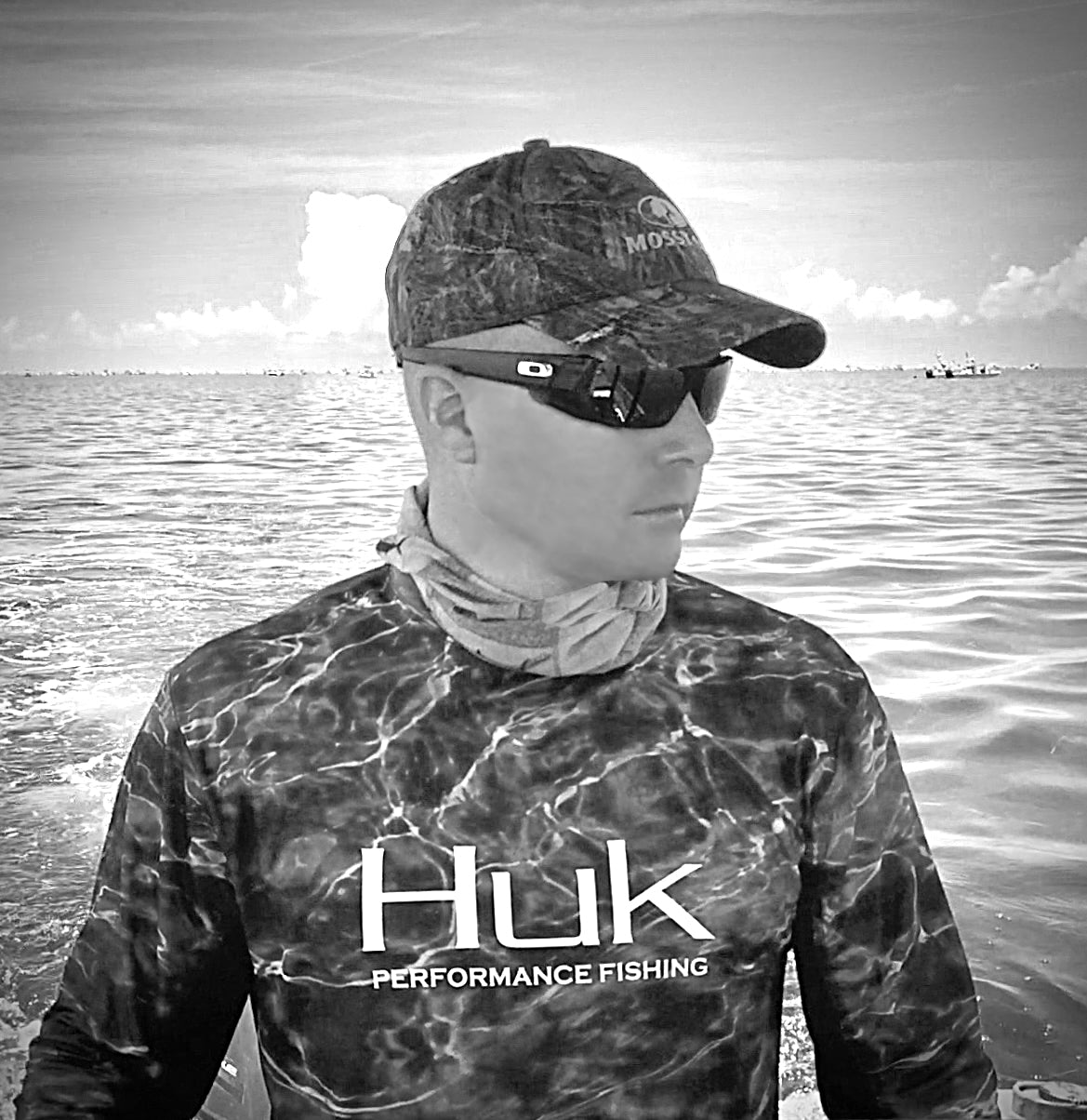 Captain Ed wearing Huk Fishing shirt while shark fishing